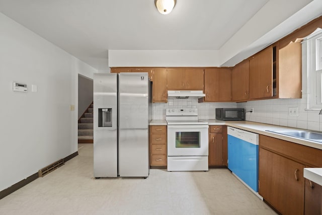 5754 Loganwood Rd, Columbus, OH 43229 - kitchen featuring white electric range, stainless steel refrigerator with ice dispenser, dishwashing machine, black microwave, and under cabinet range hood