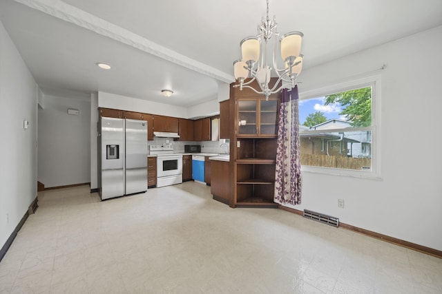 5754 Loganwood Rd, Columbus, OH 43229 - kitchen featuring stainless steel fridge, electric range, under cabinet range hood, light countertops, and baseboards