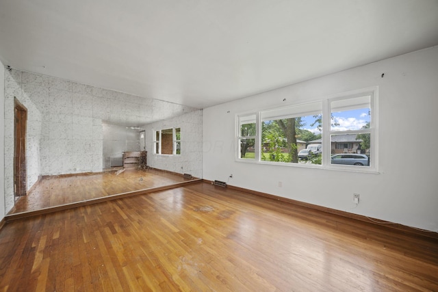 5754 Loganwood Rd, Columbus, OH 43229 - unfurnished living room with wood-type flooring and a wood stove