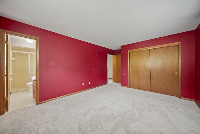 5754 Loganwood Rd, Columbus, OH 43229 - unfurnished bedroom featuring carpet floors, a closet, and ensuite bath