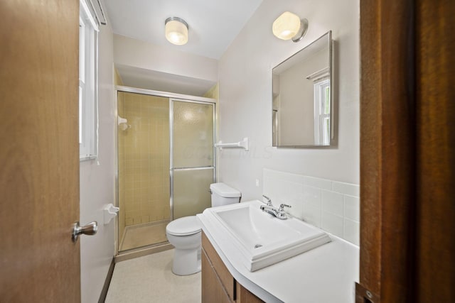 5754 Loganwood Rd, Columbus, OH 43229 - full bathroom featuring toilet, vanity, a stall shower, and backsplash
