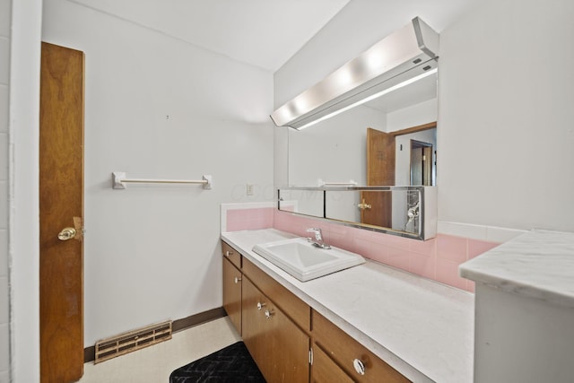 5754 Loganwood Rd, Columbus, OH 43229 - bathroom featuring vanity, backsplash, and baseboards