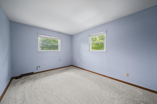5754 Loganwood Rd, Columbus, OH 43229 - carpeted empty room featuring plenty of natural light and baseboards