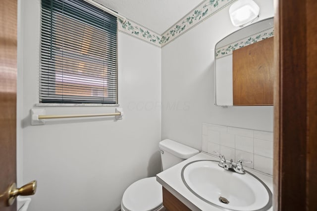5754 Loganwood Rd, Columbus, OH 43229 - bathroom with toilet, vanity, and backsplash