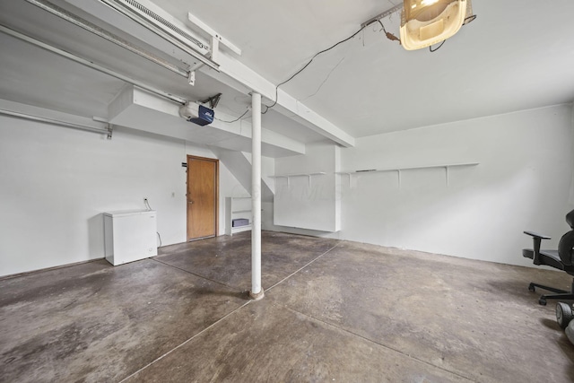 5754 Loganwood Rd, Columbus, OH 43229 - garage with refrigerator and a garage door opener