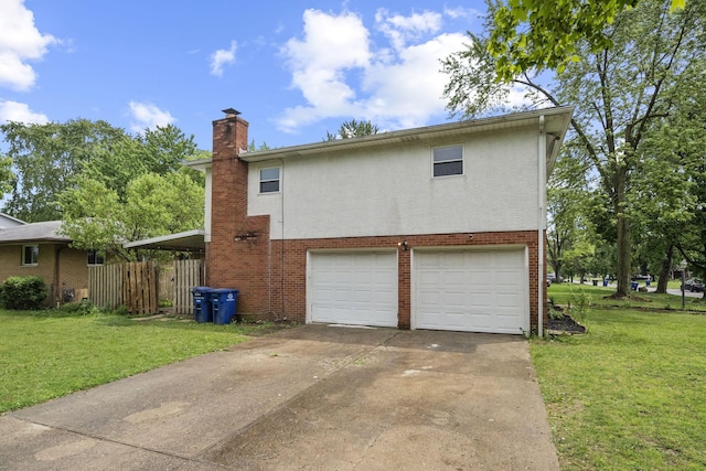 5754 Loganwood Rd, Columbus, OH 43229 - view of side of property with an attached garage, a chimney, driveway, and a yard