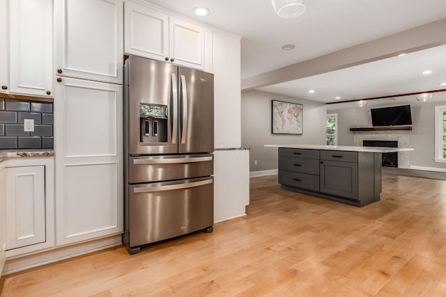 6900 Waterloo Rd NW, Canal Winchester, OH 43110 - kitchen featuring stainless steel fridge with ice dispenser, white cabinetry, light wood-style floors, tasteful backsplash, and recessed lighting