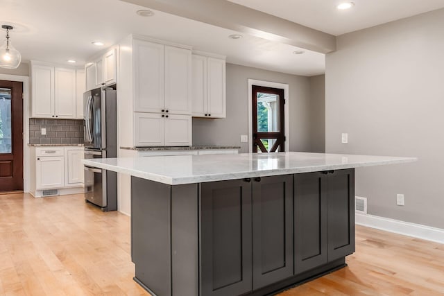6900 Waterloo Rd NW, Canal Winchester, OH 43110 - kitchen with freestanding refrigerator, white cabinetry, light wood-style floors, tasteful backsplash, and recessed lighting