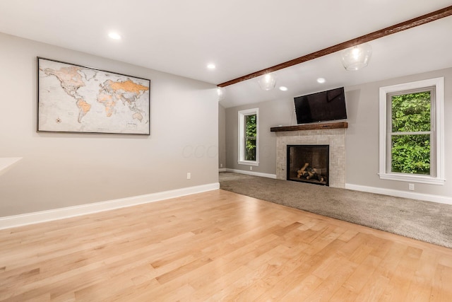 6900 Waterloo Rd NW, Canal Winchester, OH 43110 - unfurnished living room with plenty of natural light, a fireplace, wood finished floors, beamed ceiling, and recessed lighting