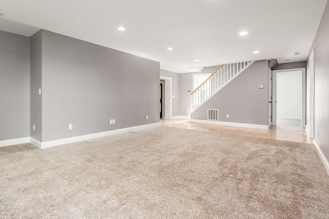 6900 Waterloo Rd NW, Canal Winchester, OH 43110 - unfurnished living room with light carpet, stairs, and recessed lighting