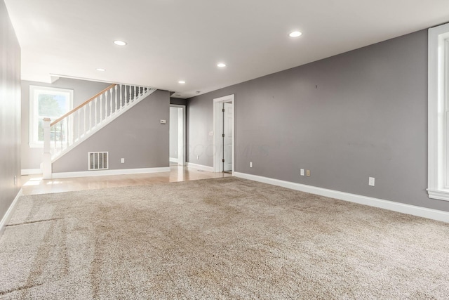 6900 Waterloo Rd NW, Canal Winchester, OH 43110 - unfurnished living room with carpet, stairs, and recessed lighting