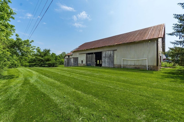6900 Waterloo Rd NW, Canal Winchester, OH 43110 - back of house featuring a lawn, an outbuilding, and a metal roof