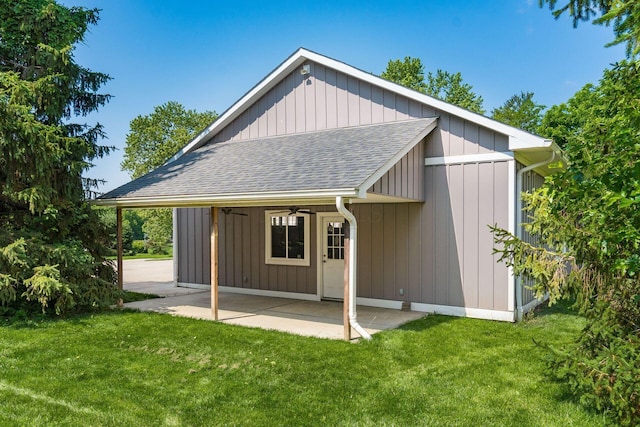 6900 Waterloo Rd NW, Canal Winchester, OH 43110 - back of property with roof with shingles, a ceiling fan, a lawn, a patio, and board and batten siding
