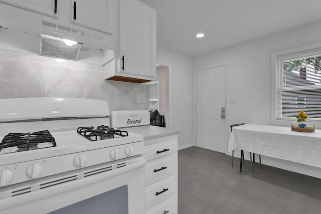 2217 Grasmere Ave, Columbus, OH 43211 - kitchen with white gas range, exhaust hood, white cabinetry, light countertops, and recessed lighting