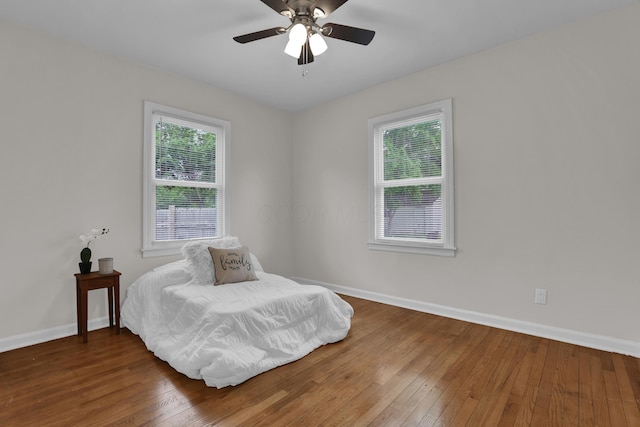 2217 Grasmere Ave, Columbus, OH 43211 - bedroom with multiple windows, baseboards, and hardwood / wood-style flooring