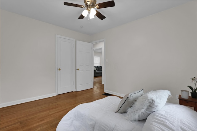 2217 Grasmere Ave, Columbus, OH 43211 - bedroom with baseboards, wood finished floors, and a ceiling fan
