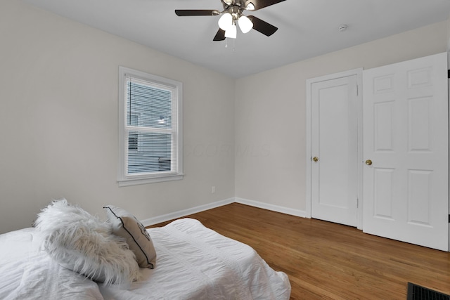2217 Grasmere Ave, Columbus, OH 43211 - bedroom with wood finished floors, baseboards, and a ceiling fan