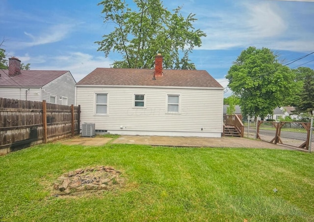 2217 Grasmere Ave, Columbus, OH 43211 - back of house with a chimney, a shingled roof, central air condition unit, and a patio area