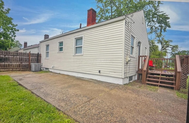 2217 Grasmere Ave, Columbus, OH 43211 - view of side of home featuring a chimney, a deck, and central air condition unit