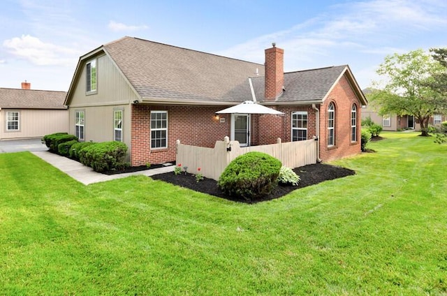 560 Dandy Brush Ln E, Columbus, OH 43230 - rear view of property featuring brick siding, a chimney, and a shingled roof