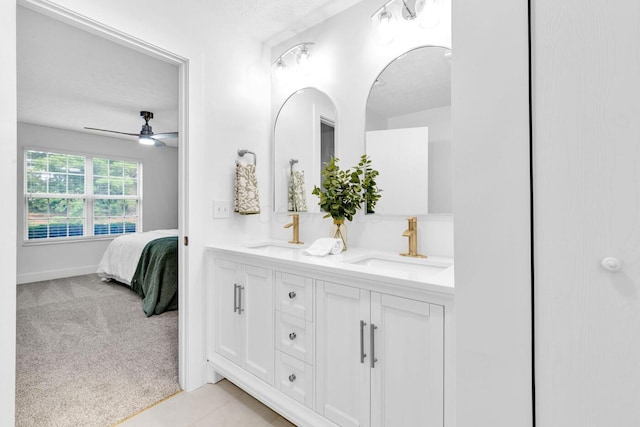 560 Dandy Brush Ln E, Columbus, OH 43230 - full bath with double vanity, ceiling fan, ensuite bathroom, and a textured ceiling