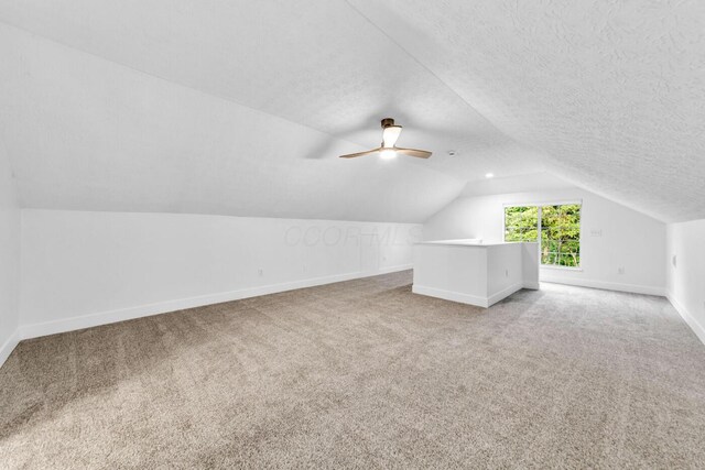 560 Dandy Brush Ln E, Columbus, OH 43230 - bonus room featuring baseboards, vaulted ceiling, carpet, a textured ceiling, and ceiling fan