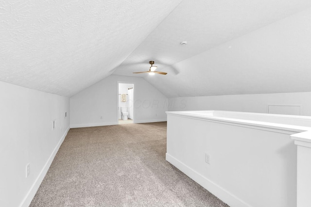 560 Dandy Brush Ln E, Columbus, OH 43230 - additional living space featuring light colored carpet, vaulted ceiling, baseboards, a ceiling fan, and a textured ceiling