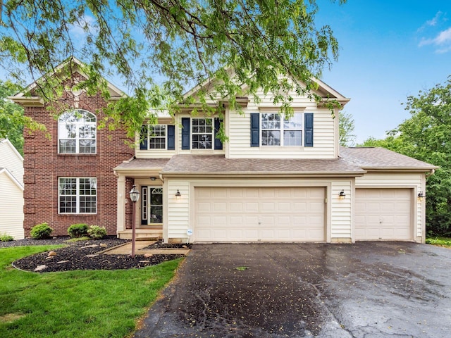 7034 Kellogg Dr, Powell, OH 43065 - view of front facade featuring asphalt driveway, an attached garage, brick siding, and a shingled roof