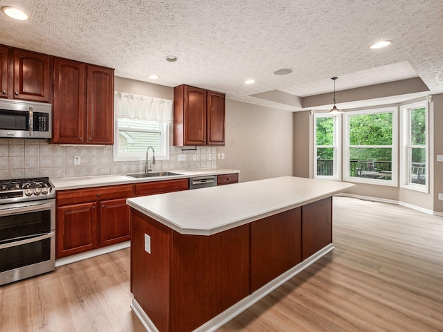 7034 Kellogg Dr, Powell, OH 43065 - kitchen featuring stainless steel appliances, a sink, light wood-style floors, light countertops, and tasteful backsplash