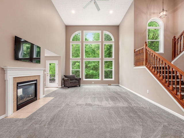 7034 Kellogg Dr, Powell, OH 43065 - living room with baseboards, ceiling fan, carpet floors, healthy amount of natural light, and a towering ceiling