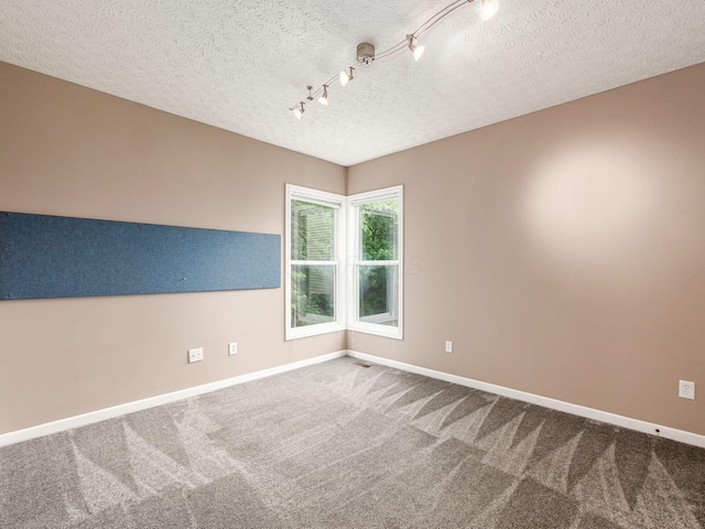 7034 Kellogg Dr, Powell, OH 43065 - carpeted spare room featuring baseboards, rail lighting, and a textured ceiling