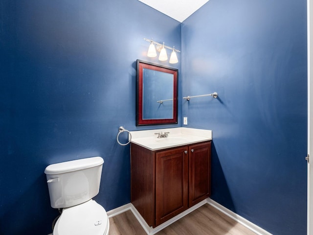7034 Kellogg Dr, Powell, OH 43065 - half bath featuring toilet, wood finished floors, vanity, and baseboards