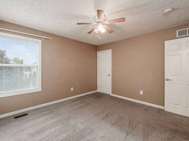 7034 Kellogg Dr, Powell, OH 43065 - spare room with carpet, ceiling fan, baseboards, and a textured ceiling