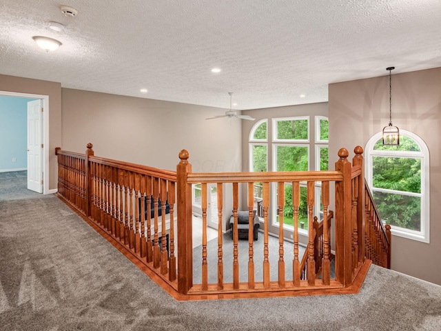 7034 Kellogg Dr, Powell, OH 43065 - hall with an upstairs landing, carpet floors, a textured ceiling, recessed lighting, and baseboards