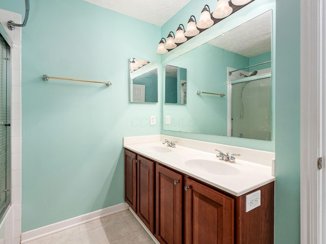 7034 Kellogg Dr, Powell, OH 43065 - bathroom with tiled shower, double vanity, baseboards, and a textured ceiling