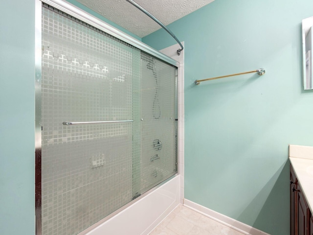 7034 Kellogg Dr, Powell, OH 43065 - full bath with shower / bath combination with glass door, vanity, tile patterned floors, baseboards, and a textured ceiling