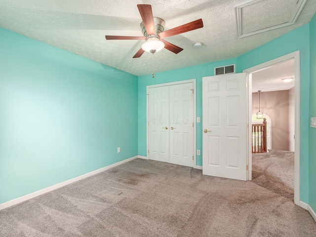 7034 Kellogg Dr, Powell, OH 43065 - unfurnished bedroom featuring carpet floors, a textured ceiling, a closet, baseboards, and a ceiling fan
