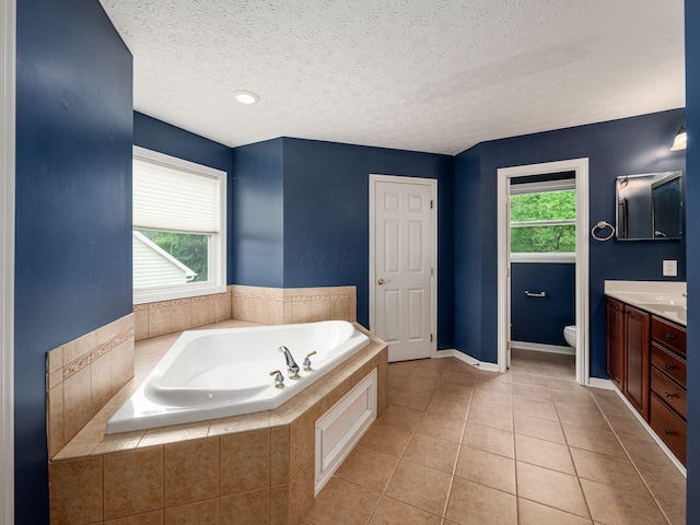 7034 Kellogg Dr, Powell, OH 43065 - bathroom with vanity, a garden tub, toilet, tile patterned floors, and a textured ceiling