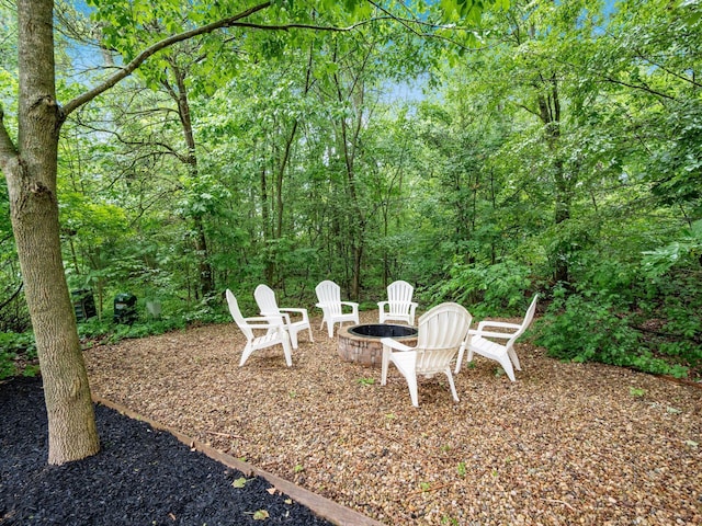 7034 Kellogg Dr, Powell, OH 43065 - view of yard with an outdoor fire pit and a view of trees
