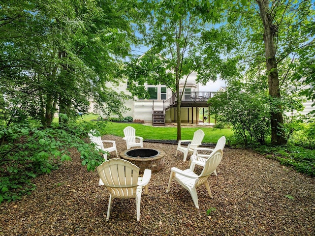 7034 Kellogg Dr, Powell, OH 43065 - view of grassy yard featuring stairway, an outdoor fire pit, and a deck