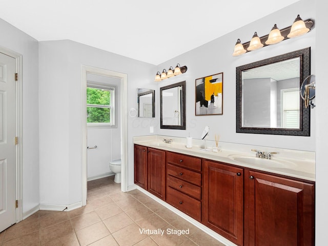 7034 Kellogg Dr, Powell, OH 43065 - bathroom with double vanity, toilet, tile patterned floors, and baseboards