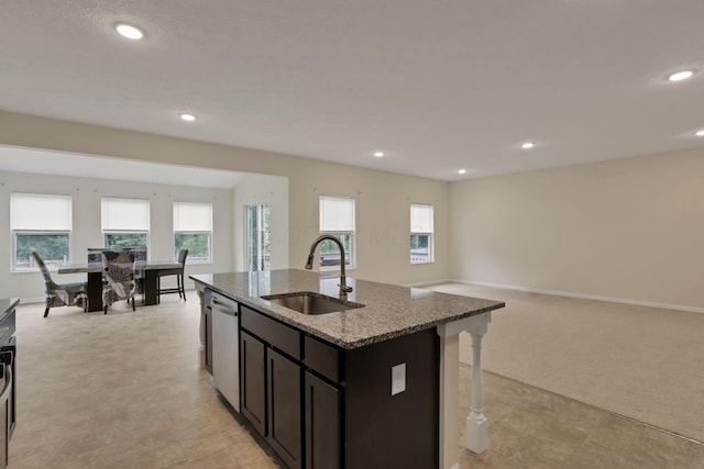 1137 Legacy Ln, Pataskala, OH 43062 - kitchen featuring a sink, dishwasher, dark stone countertops, a kitchen island with sink, and recessed lighting