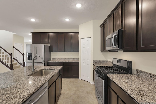 1137 Legacy Ln, Pataskala, OH 43062 - kitchen with stainless steel appliances, a sink, light stone countertops, dark brown cabinetry, and recessed lighting