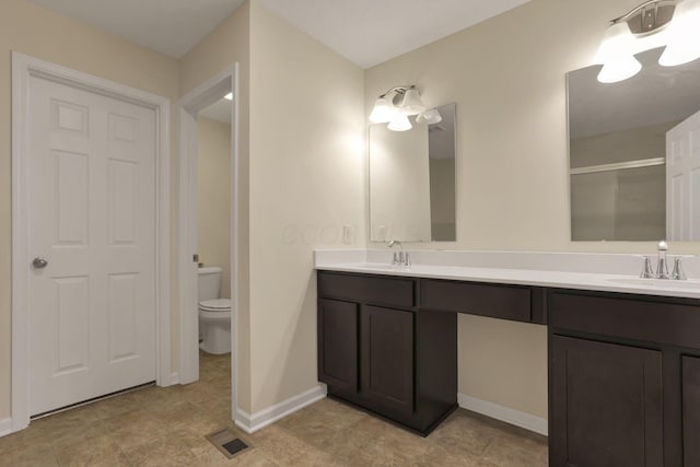 1137 Legacy Ln, Pataskala, OH 43062 - full bathroom with double vanity, toilet, a shower with door, and baseboards