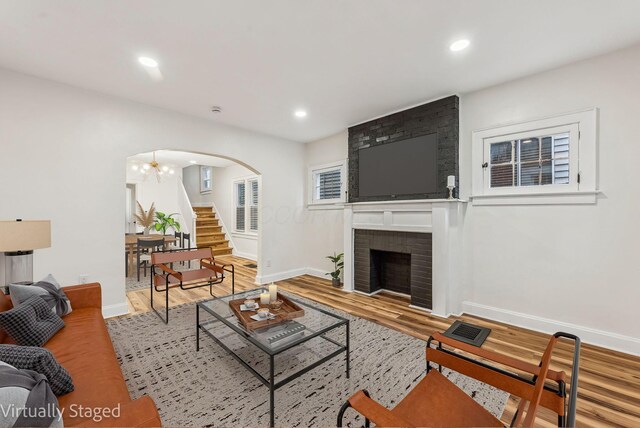 1113-1115 S Ohio Ave, Columbus, OH 43206 - living area with arched walkways, wood finished floors, baseboards, stairway, and recessed lighting