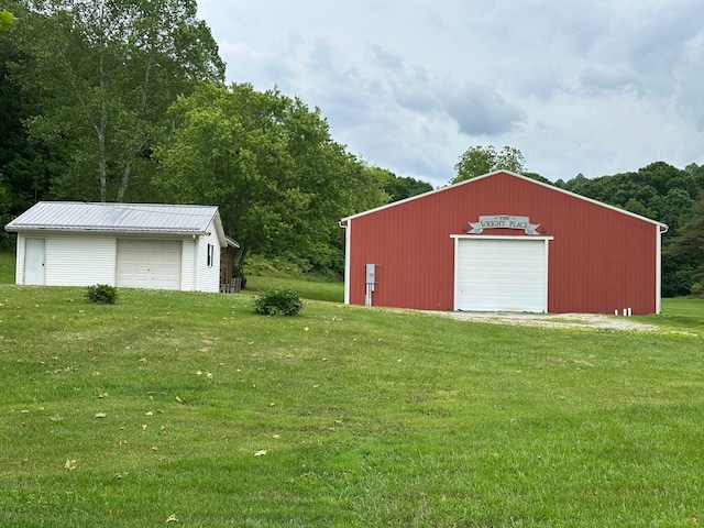 14572 Hock Hocking Rd, Logan, OH 43138 - view of grassy yard featuring a garage and an outbuilding