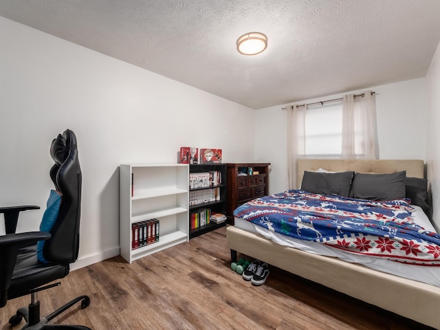 334 Wittenberg St, Columbus, OH 43230 - bedroom with wood finished floors and a textured ceiling