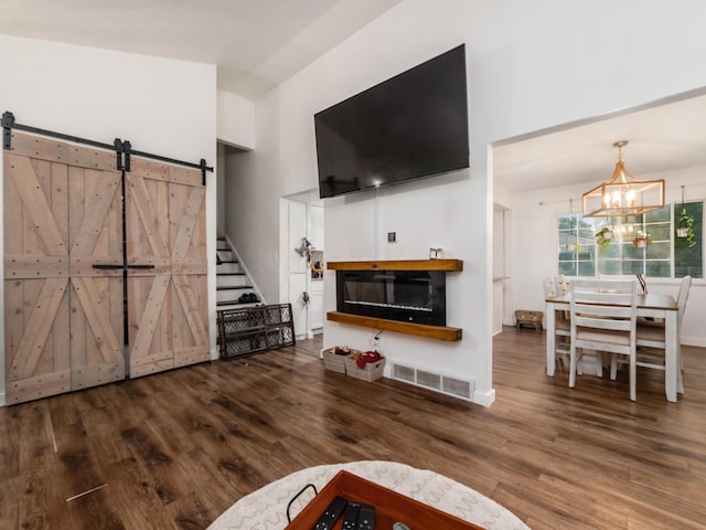 334 Wittenberg St, Columbus, OH 43230 - living room with a towering ceiling, a chandelier, wood finished floors, stairs, and a barn door