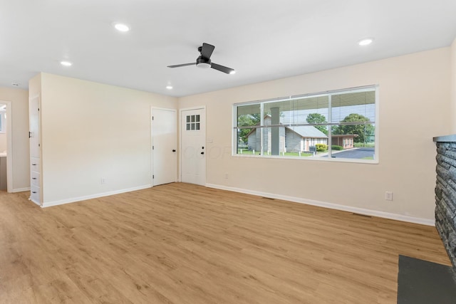 1345 E Deshler Ave, Columbus, OH 43206 - unfurnished living room with light wood finished floors, a ceiling fan, baseboards, recessed lighting, and a fireplace