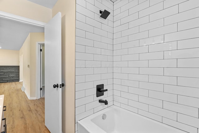 1345 E Deshler Ave, Columbus, OH 43206 - bathroom with wood finished floors, tub / shower combination, baseboards, and vanity